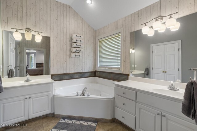 408 Abbey Woods, Brandon, MS 39047 - full bathroom featuring lofted ceiling, a garden tub, two vanities, ensuite bath, and tile patterned floors