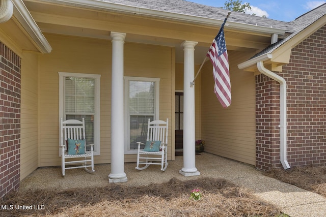 408 Abbey Woods, Brandon, MS 39047 - view of exterior entry featuring brick siding, covered porch, and roof with shingles