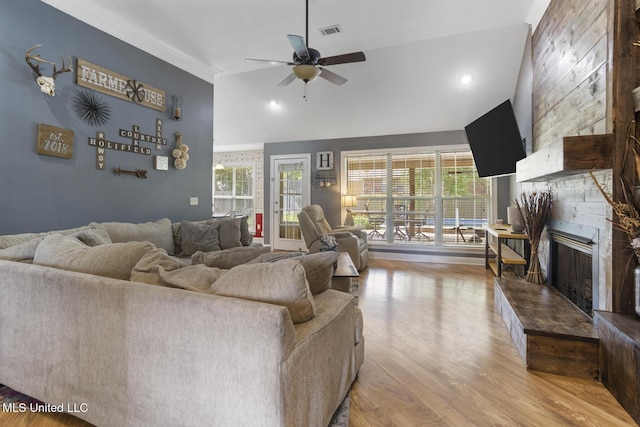 408 Abbey Woods, Brandon, MS 39047 - living area featuring a large fireplace, a ceiling fan, light wood-style flooring, and high vaulted ceiling