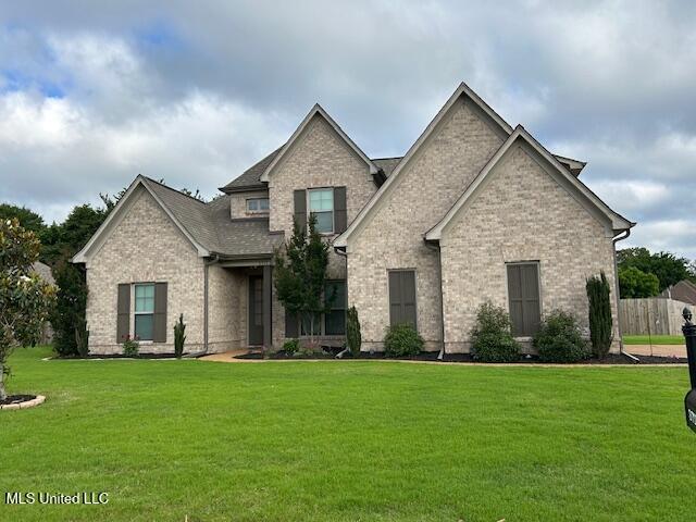 3717 Beech Tree Cv, Southaven, MS 38672 - craftsman house with a front yard and brick siding