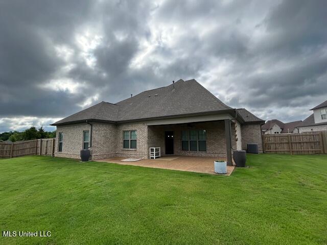 3717 Beech Tree Cv, Southaven, MS 38672 - rear view of house with a patio area, central AC, brick siding, and a shingled roof