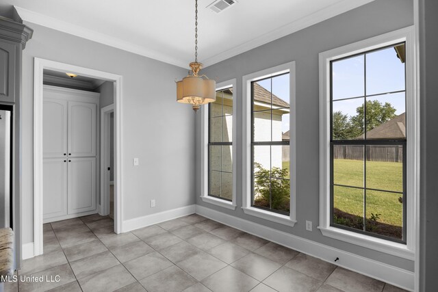 unfurnished dining area with baseboards, visible vents, ornamental molding, and light tile patterned floors