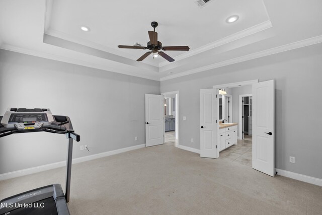 exercise area with crown molding, light carpet, ceiling fan, recessed lighting, and a tray ceiling