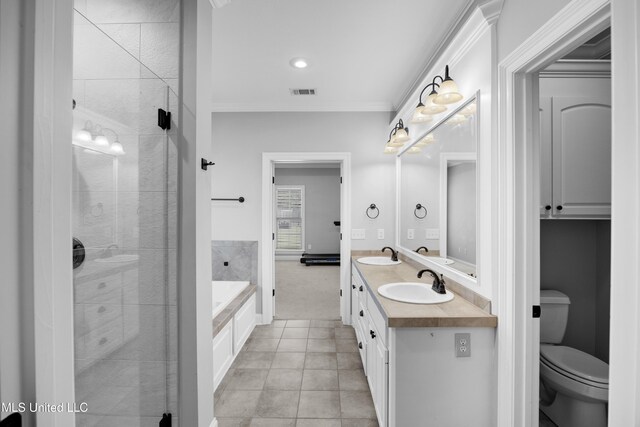 bathroom with a sink, tile patterned floors, toilet, and a bath