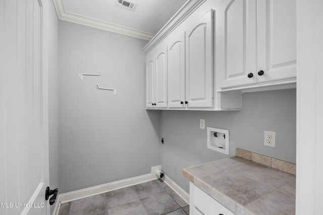 laundry room with cabinet space, crown molding, washer hookup, hookup for an electric dryer, and visible vents