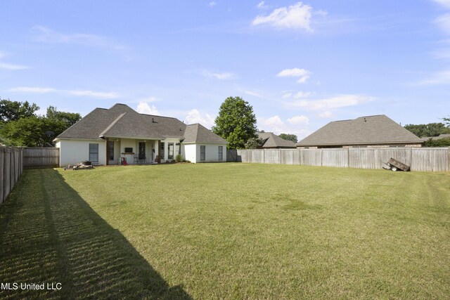 view of yard with a fenced backyard