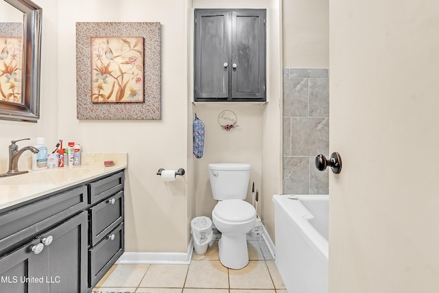 231 Hickory Ln, Batesville, MS 38606 - bathroom featuring vanity, toilet, a tub, baseboards, and tile patterned flooring