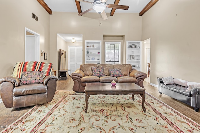 231 Hickory Ln, Batesville, MS 38606 - living room with ceiling fan, wood finished floors, a high ceiling, crown molding, and baseboards