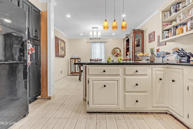 231 Hickory Ln, Batesville, MS 38606 - kitchen with dark countertops, ornamental molding, light wood-style floors, decorative light fixtures, and a peninsula