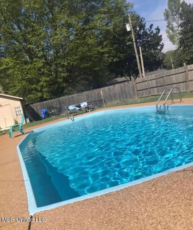 231 Hickory Ln, Batesville, MS 38606 - view of swimming pool featuring a fenced backyard and an outdoor structure