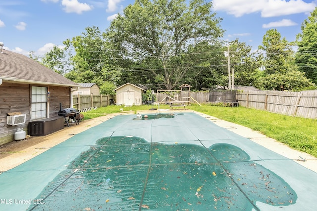231 Hickory Ln, Batesville, MS 38606 - view of swimming pool with a grill, central AC unit, a patio, and view of scattered trees
