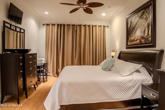 bedroom with light wood-type flooring, crown molding, and recessed lighting