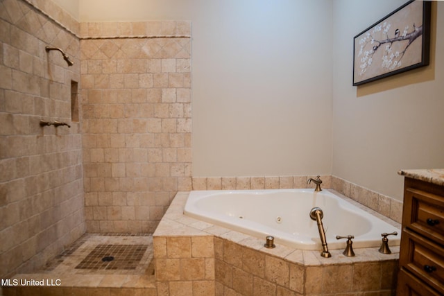 full bathroom with tiled shower, vanity, and a tub with jets