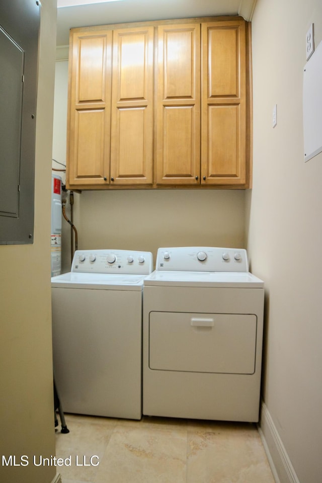 laundry area featuring baseboards, separate washer and dryer, cabinet space, and electric panel