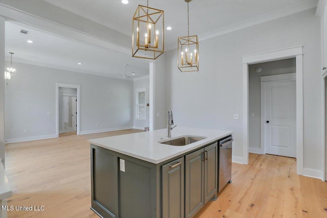 kitchen with hanging light fixtures, an island with sink, light wood-type flooring, dishwasher, and sink