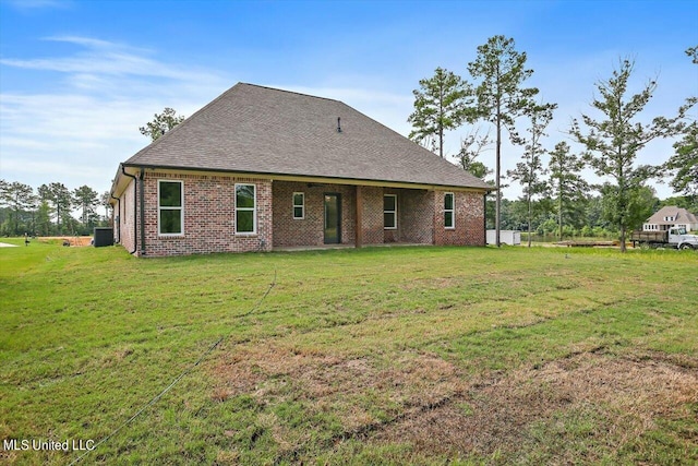 back of property featuring a lawn