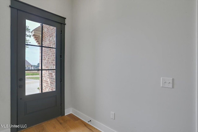 doorway to outside featuring wood-type flooring and a healthy amount of sunlight