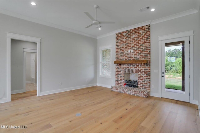 unfurnished living room featuring light hardwood / wood-style floors, a healthy amount of sunlight, and crown molding