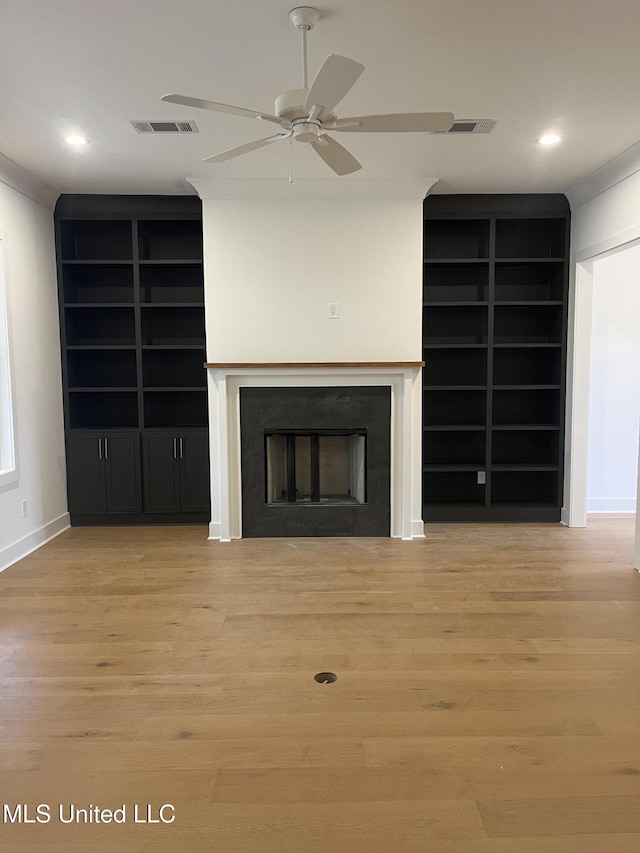 unfurnished living room featuring light wood-type flooring and ceiling fan