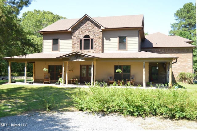 1088 S Red Banks Rd, Byhalia, MS 38611 - view of front of house with french doors, stone siding, a front yard, and a shingled roof