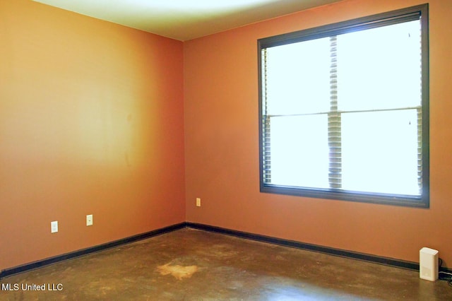 1088 S Red Banks Rd, Byhalia, MS 38611 - spare room featuring concrete flooring and baseboards