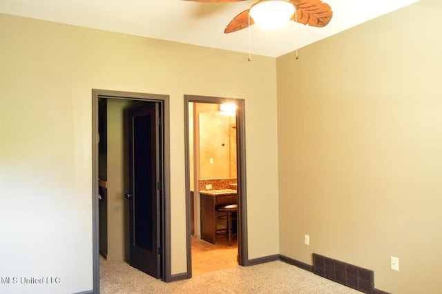 1088 S Red Banks Rd, Byhalia, MS 38611 - unfurnished bedroom with light carpet, baseboards, ensuite bathroom, and ceiling fan