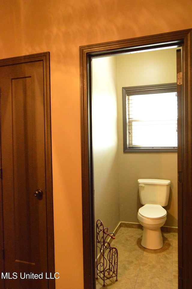 1088 S Red Banks Rd, Byhalia, MS 38611 - bathroom featuring toilet, baseboards, and tile patterned flooring