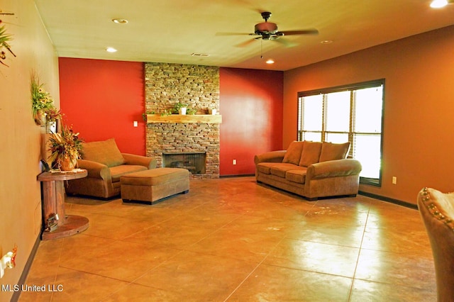 1088 S Red Banks Rd, Byhalia, MS 38611 - tiled living room featuring a stone fireplace, a ceiling fan, and recessed lighting