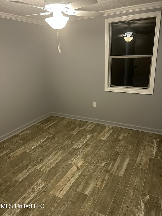 empty room featuring crown molding and dark hardwood / wood-style floors