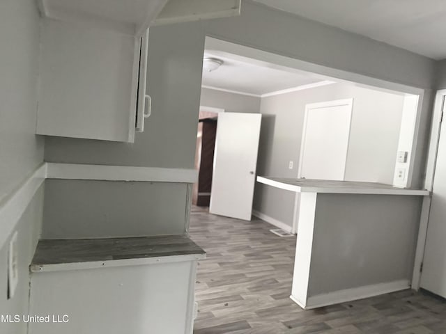 4189 Del Rosa Dr, Jackson, MS 39206 - kitchen with wood finished floors and white cabinetry