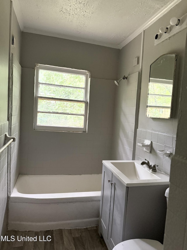 4189 Del Rosa Dr, Jackson, MS 39206 - full bath featuring tile walls, a textured ceiling, vanity, wood finished floors, and ornamental molding