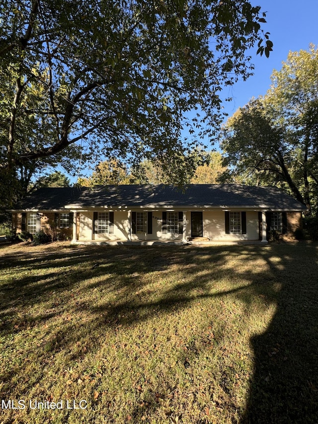 rear view of property featuring a yard