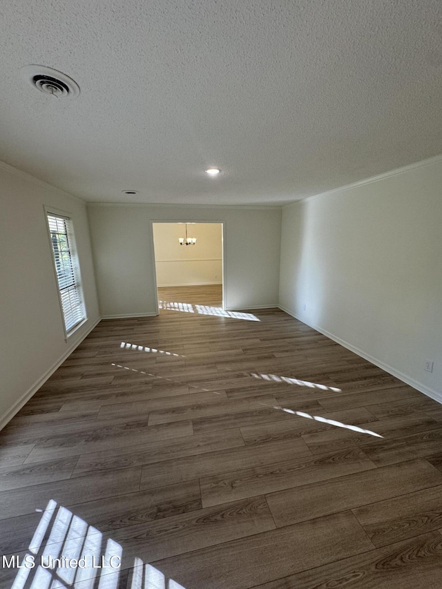 empty room with hardwood / wood-style flooring and a textured ceiling