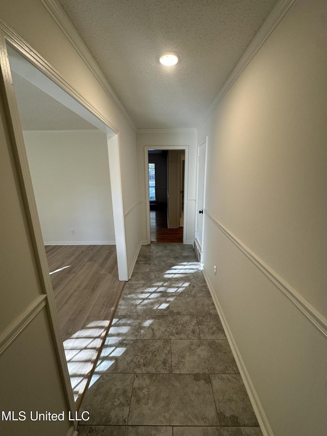 hall with ornamental molding, a textured ceiling, and dark hardwood / wood-style flooring