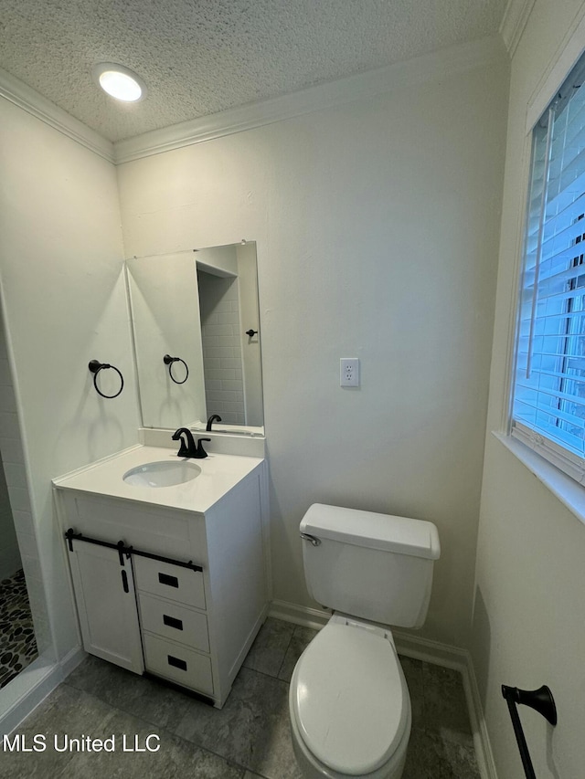 bathroom featuring a textured ceiling, toilet, tile patterned floors, tiled shower, and vanity