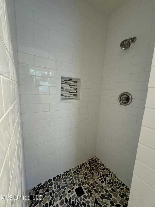 bathroom with tiled shower