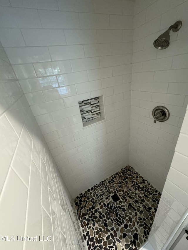 bathroom with a tile shower