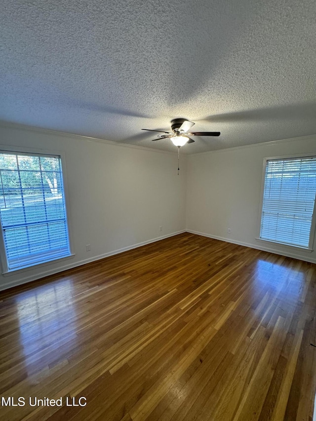 empty room featuring a textured ceiling, wood-type flooring, and ceiling fan