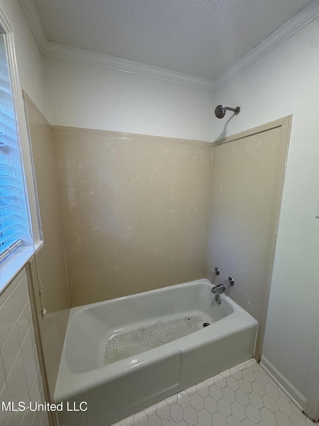 bathroom with washtub / shower combination, a textured ceiling, tile walls, ornamental molding, and tile patterned flooring