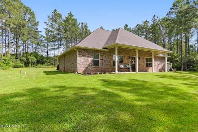3112 Eagle Ridge Rd, Vancleave, MS 39565 - back of house with brick siding, a lawn, and roof with shingles