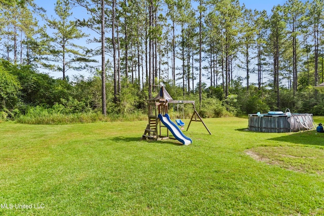 3112 Eagle Ridge Rd, Vancleave, MS 39565 - view of green lawn featuring a playground and an outdoor pool