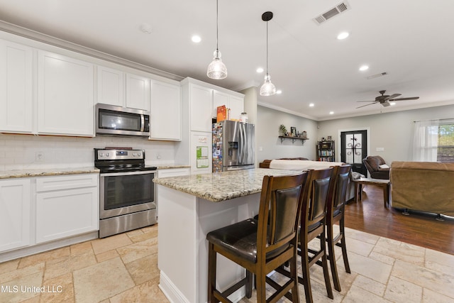 3112 Eagle Ridge Rd, Vancleave, MS 39565 - kitchen with stainless steel appliances, stone tile floors, ornamental molding, backsplash, and open floor plan