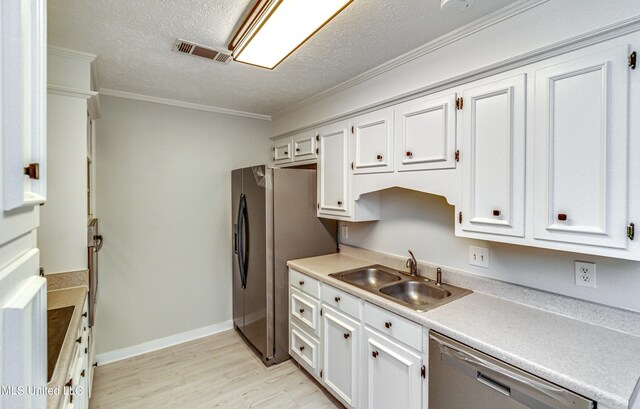 118 Bellegrove Blvd, Brandon, MS 39047 - kitchen with light wood-type flooring, a sink, appliances with stainless steel finishes, and white cabinets