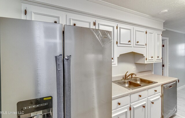 118 Bellegrove Blvd, Brandon, MS 39047 - kitchen with crown molding, a sink, white cabinets, and stainless steel appliances