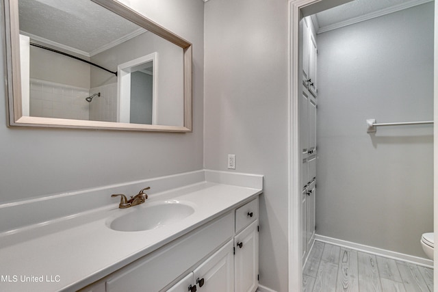 118 Bellegrove Blvd, Brandon, MS 39047 - full bathroom featuring crown molding, wood finished floors, vanity, baseboards, and toilet