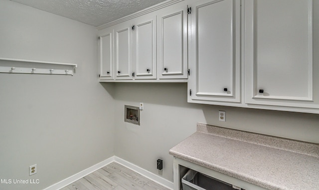 118 Bellegrove Blvd, Brandon, MS 39047 - laundry area featuring baseboards, light wood-type flooring, a textured ceiling, cabinet space, and washer hookup