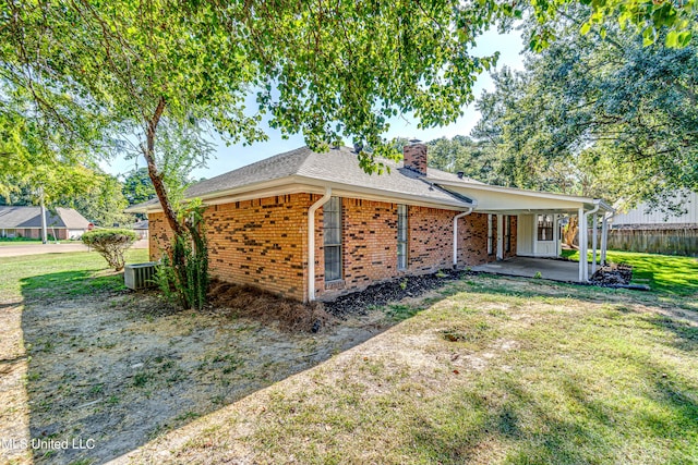 118 Bellegrove Blvd, Brandon, MS 39047 - exterior space with brick siding, a chimney, central air condition unit, a patio, and a yard