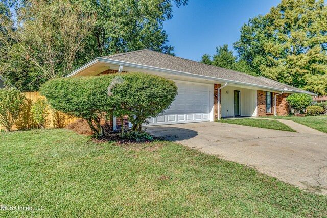 118 Bellegrove Blvd, Brandon, MS 39047 - ranch-style house with fence, an attached garage, a front lawn, brick siding, and concrete driveway