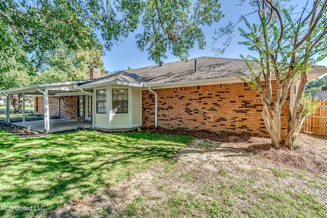 118 Bellegrove Blvd, Brandon, MS 39047 - back of property featuring fence, brick siding, a chimney, a patio area, and a yard