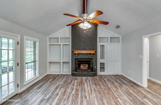 118 Bellegrove Blvd, Brandon, MS 39047 - unfurnished living room featuring a textured ceiling, vaulted ceiling, built in shelves, and visible vents